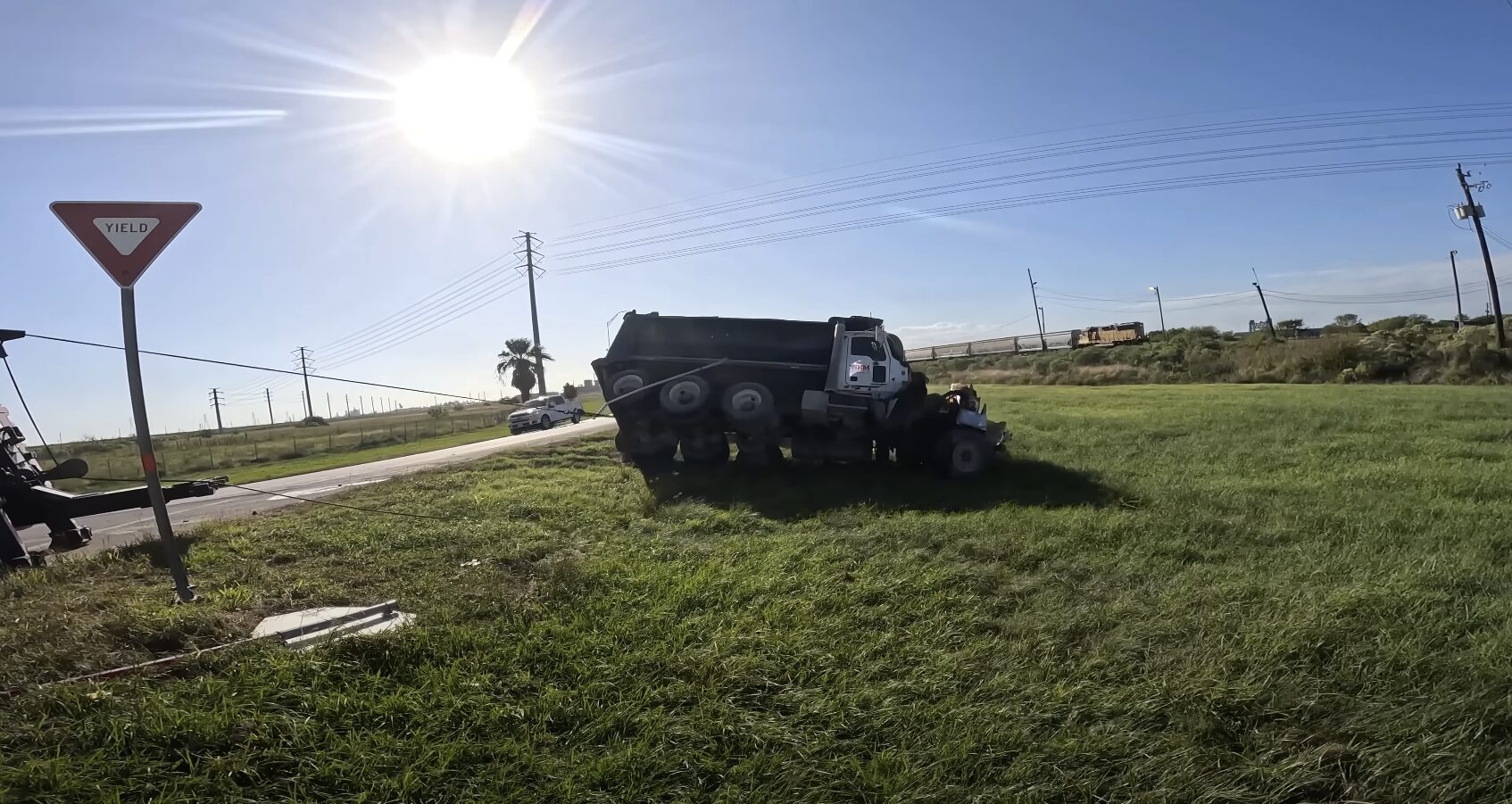 Emergency Heavy-Duty Towing and Recovery Services Large tow truck recovering overturned truck from roadside